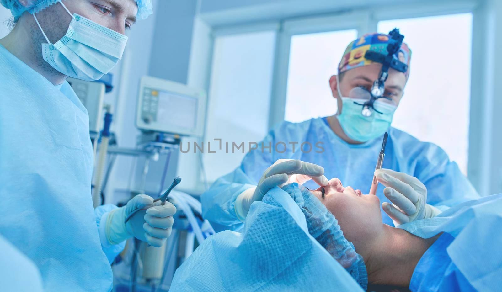 Man surgeon at work in operating room.