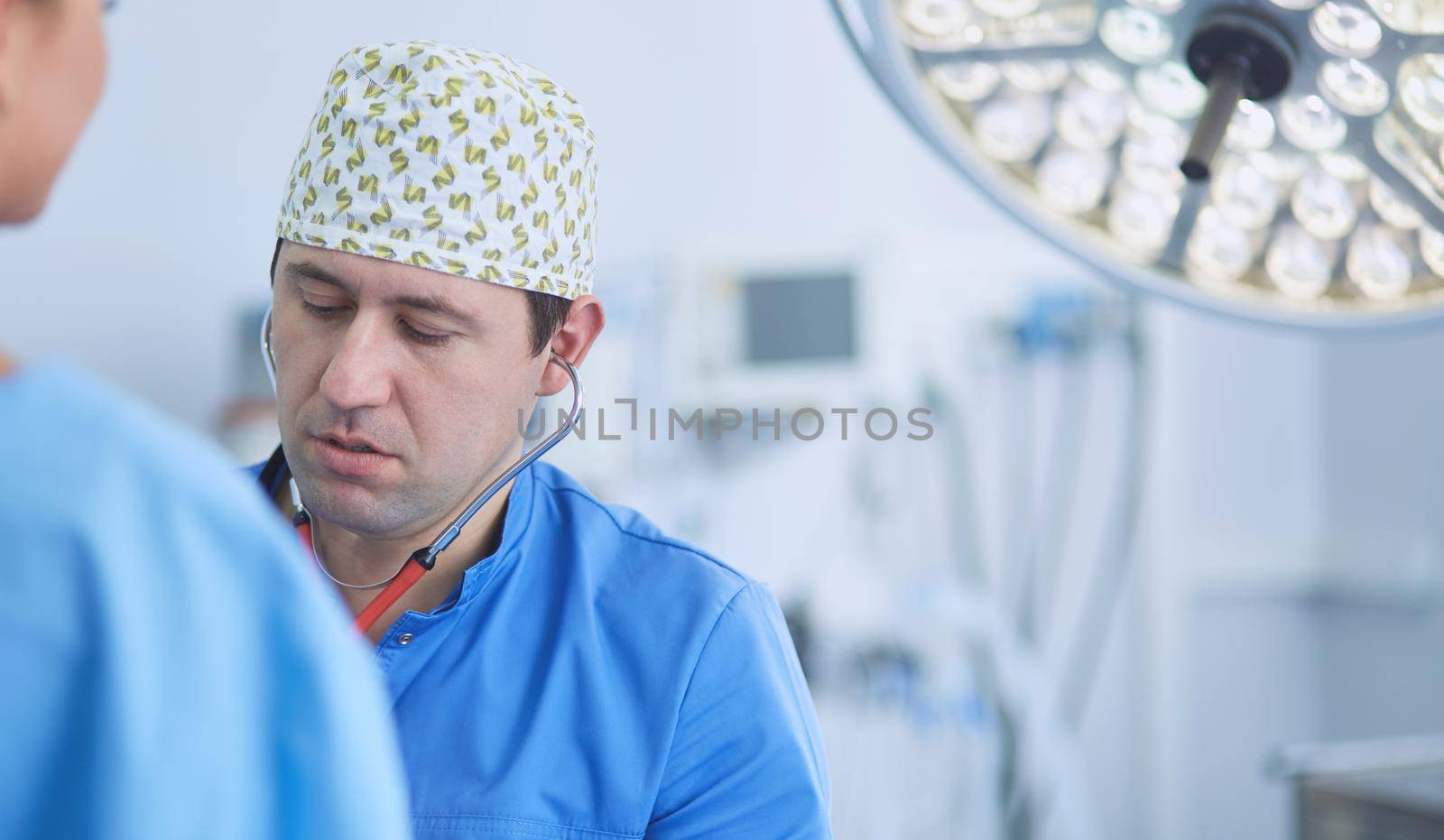 Man surgeon at work in operating room.