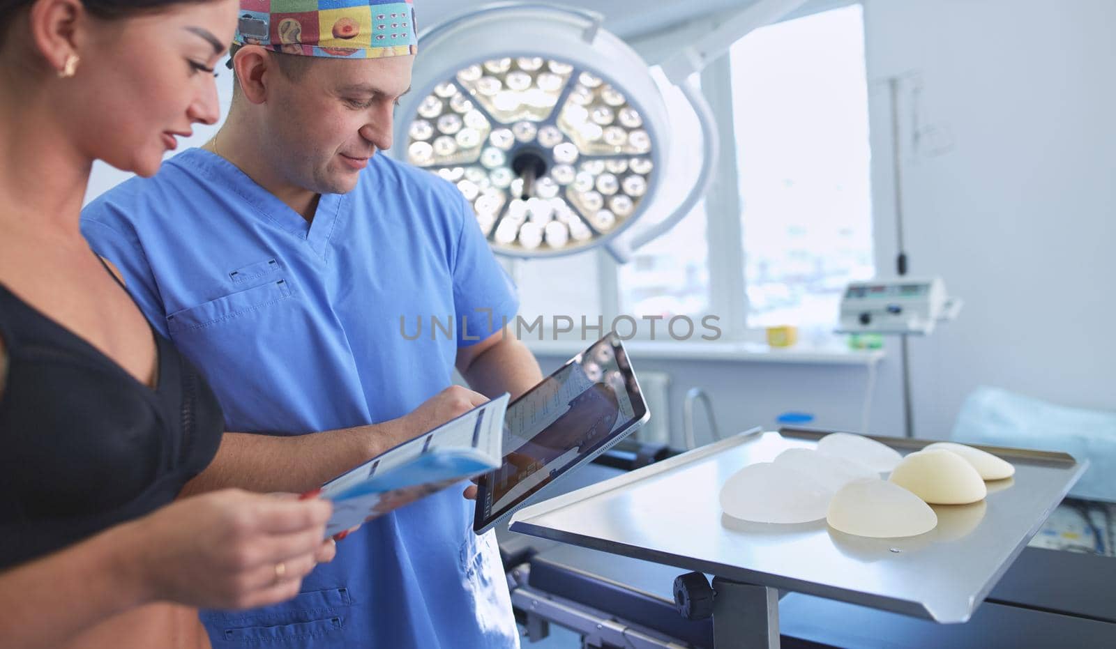Doctor showing young patient her chest in his office at the hospital.