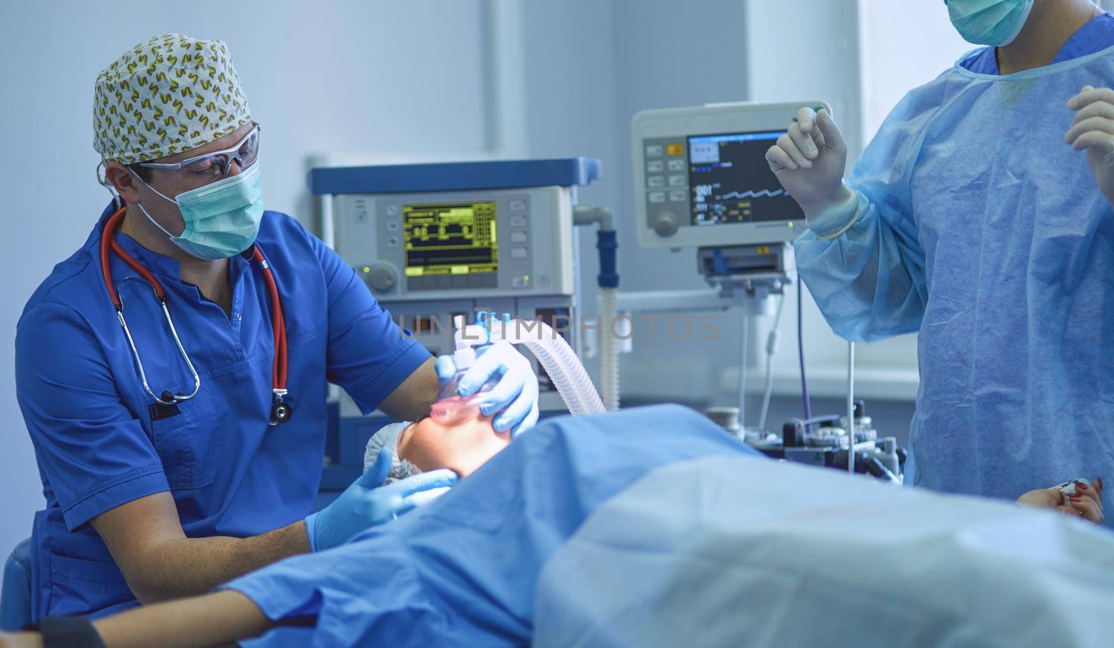 Man surgeon at work in operating room.