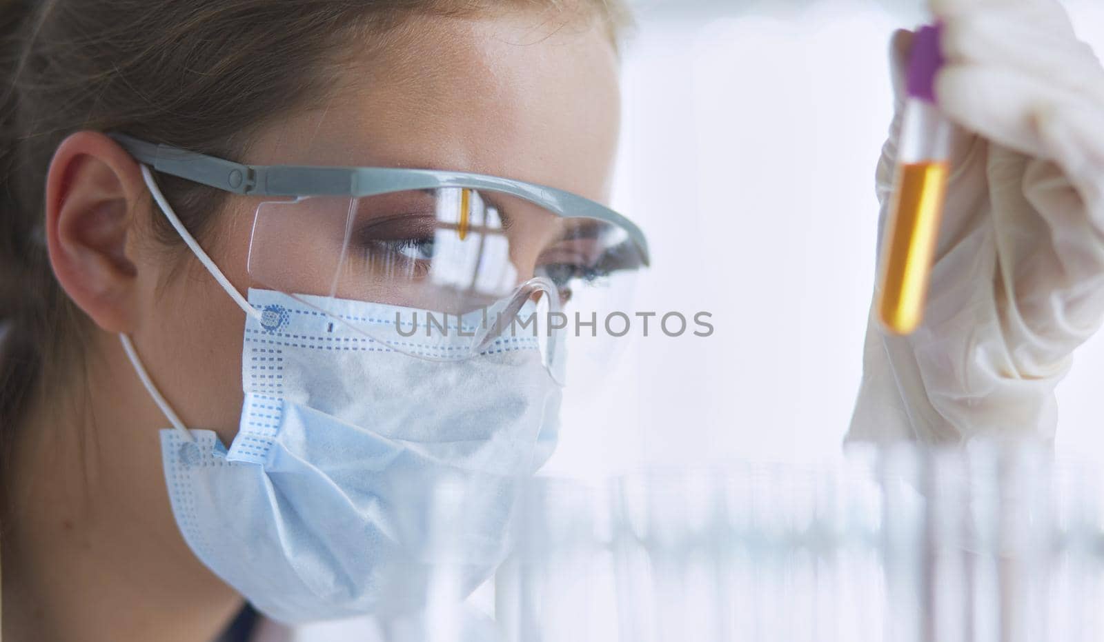 Researcher, doctor, scientist or laboratory assistant working with plastic medical tubes in modern lab or hospital.