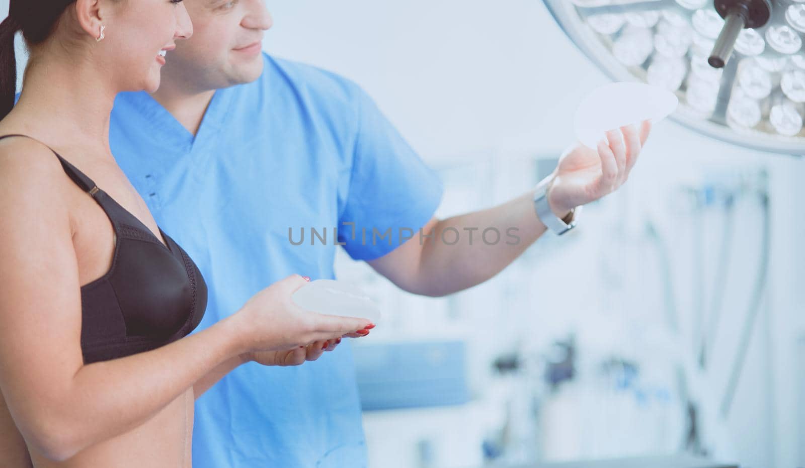 Doctor showing young patient her chest in his office at the hospital.