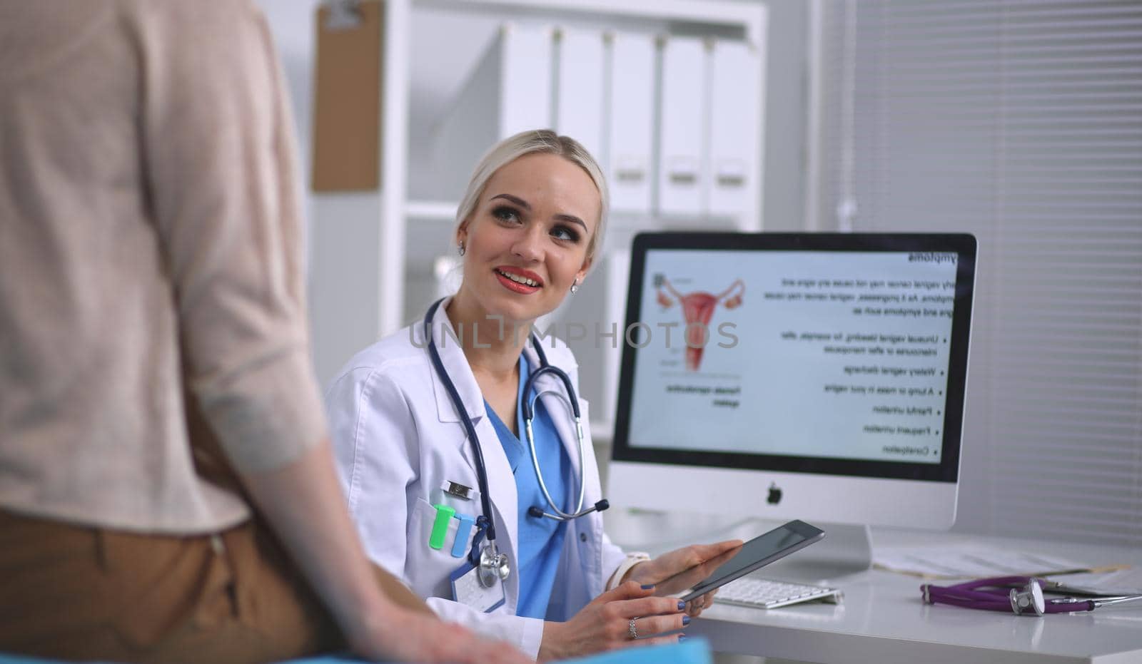 Doctor and patient discussing something while sitting at the table . Medicine and health care concept. Doctor and patient.