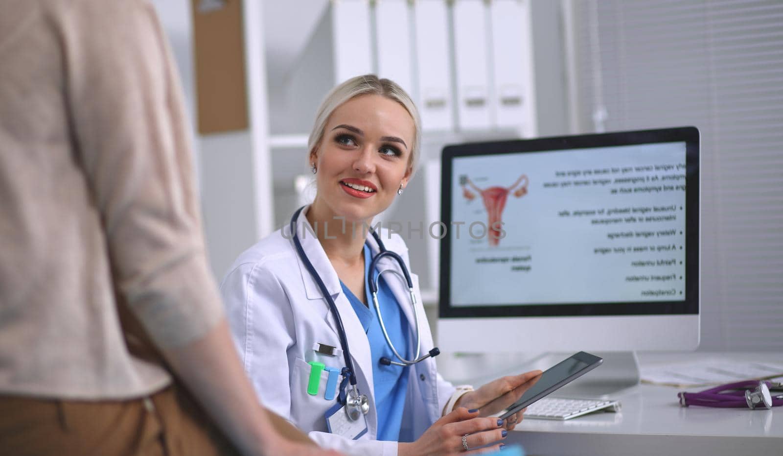 Doctor and patient discussing something while sitting at the table . Medicine and health care concept. Doctor and patient.