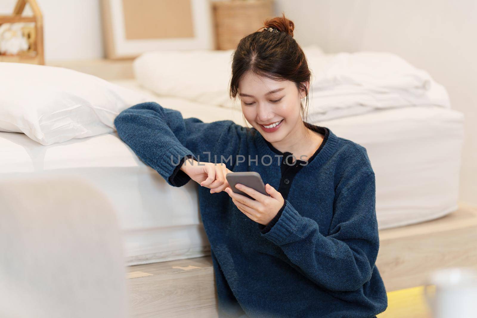 Young woman playing games on smartphone. Woman using video streamning. technology and people concept