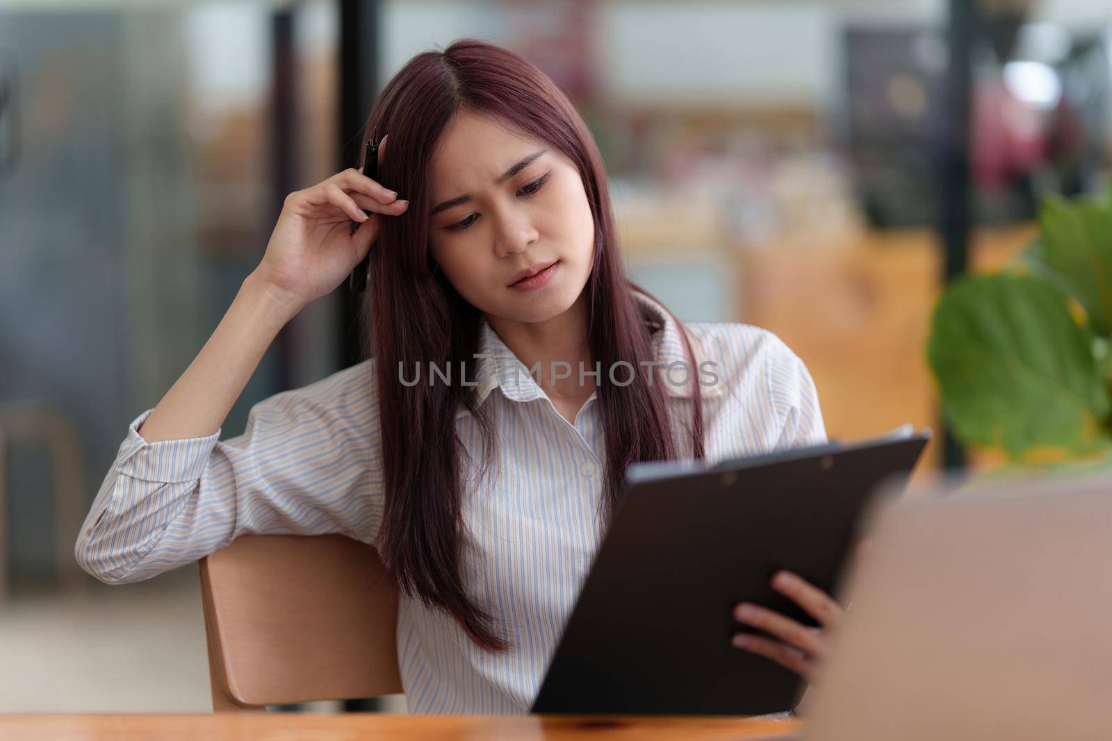 Image of Young woman stressed while reading a book for exam at library at school. back to school concept