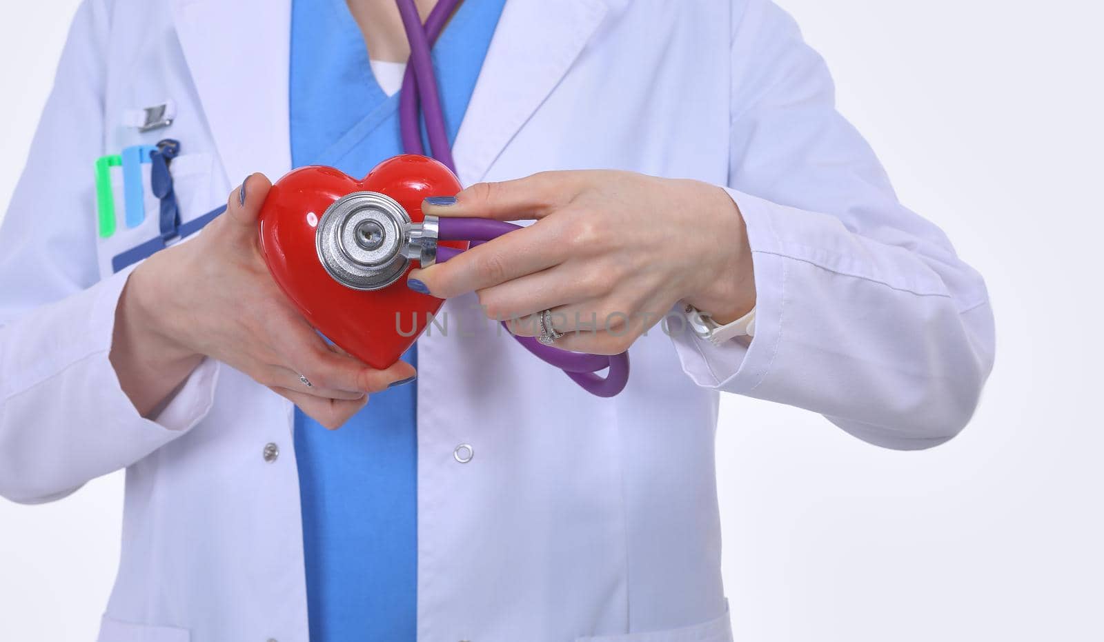 Young woman doctor holding a red heart, isolated on white background. Woman doctor.