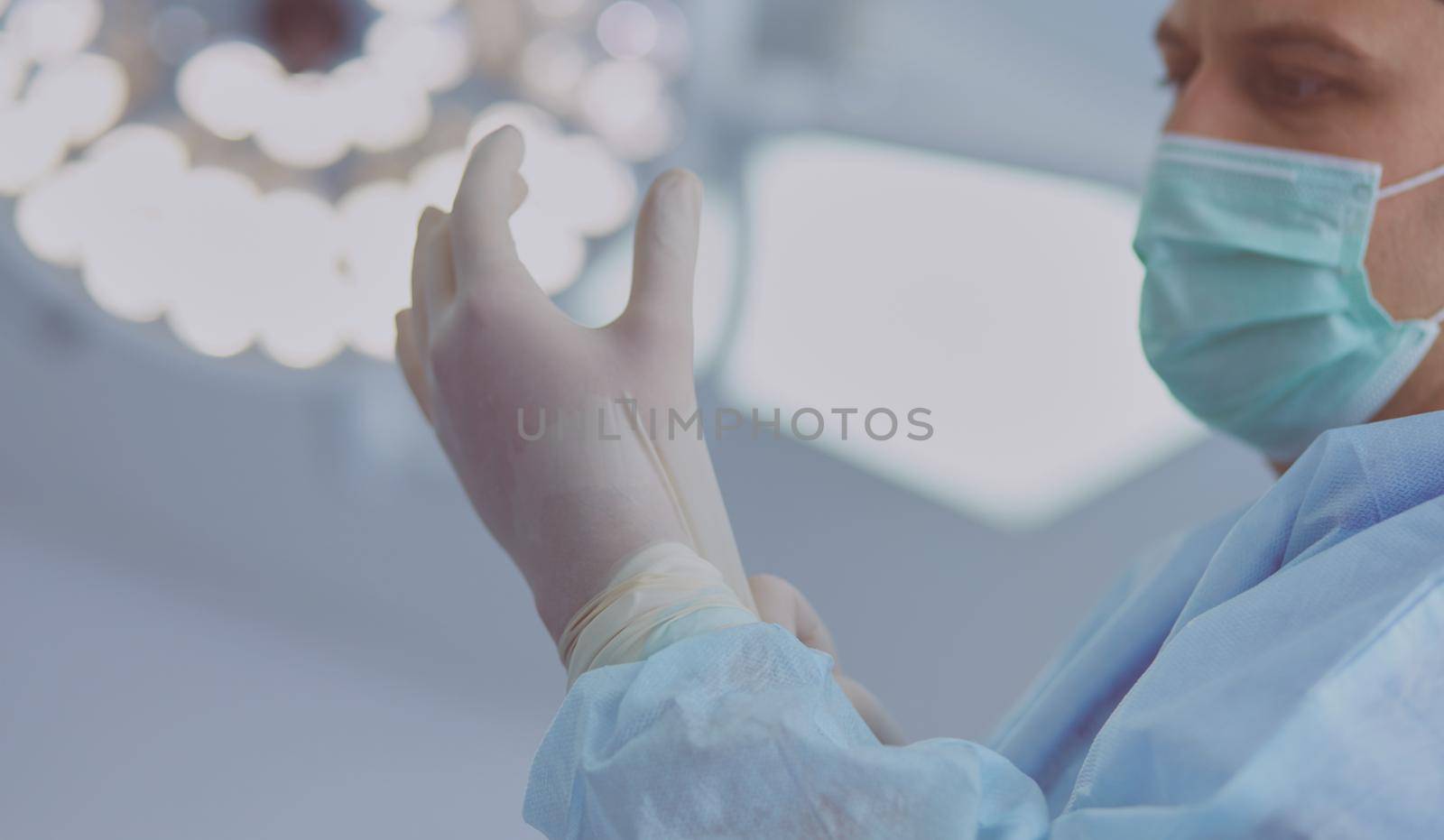 Man surgeon at work in operating room.