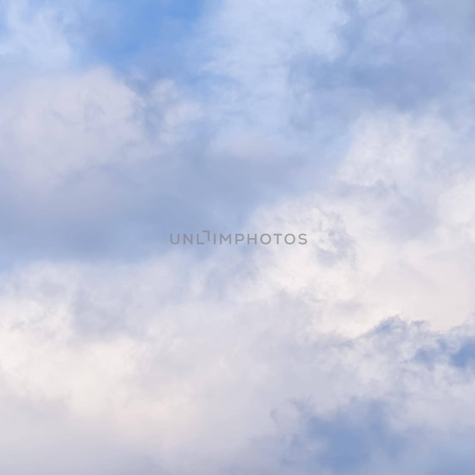 Background of cloudy sky with pale pink clouds at sunset