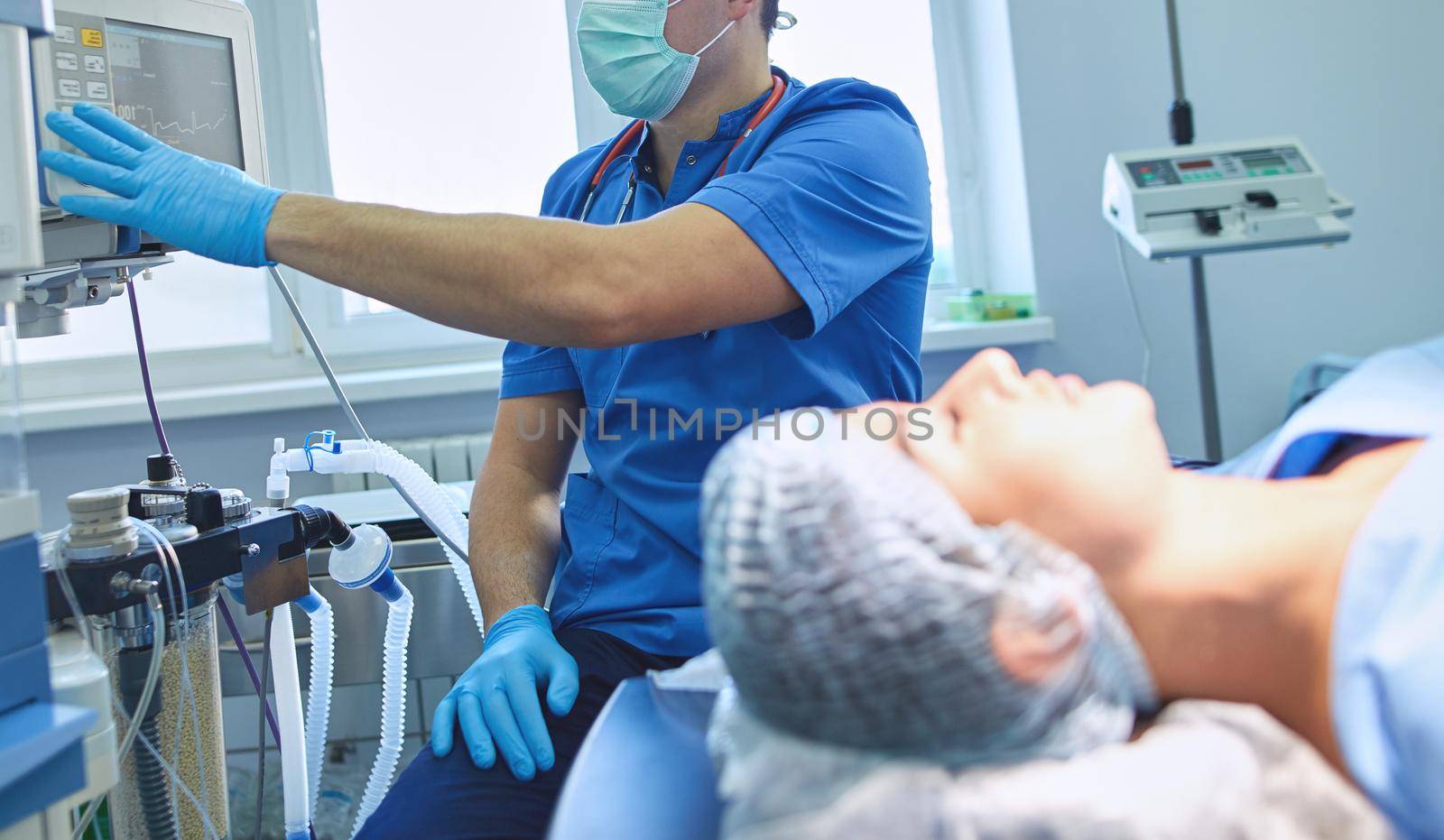 Man surgeon at work in operating room.