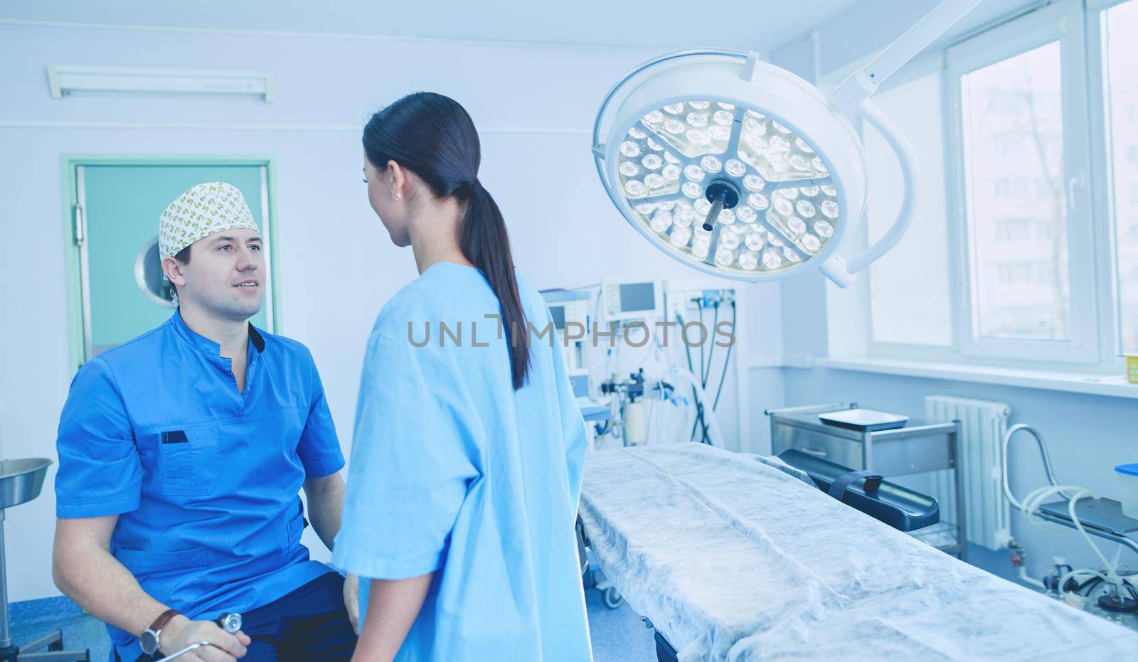 Man surgeon at work in operating room.