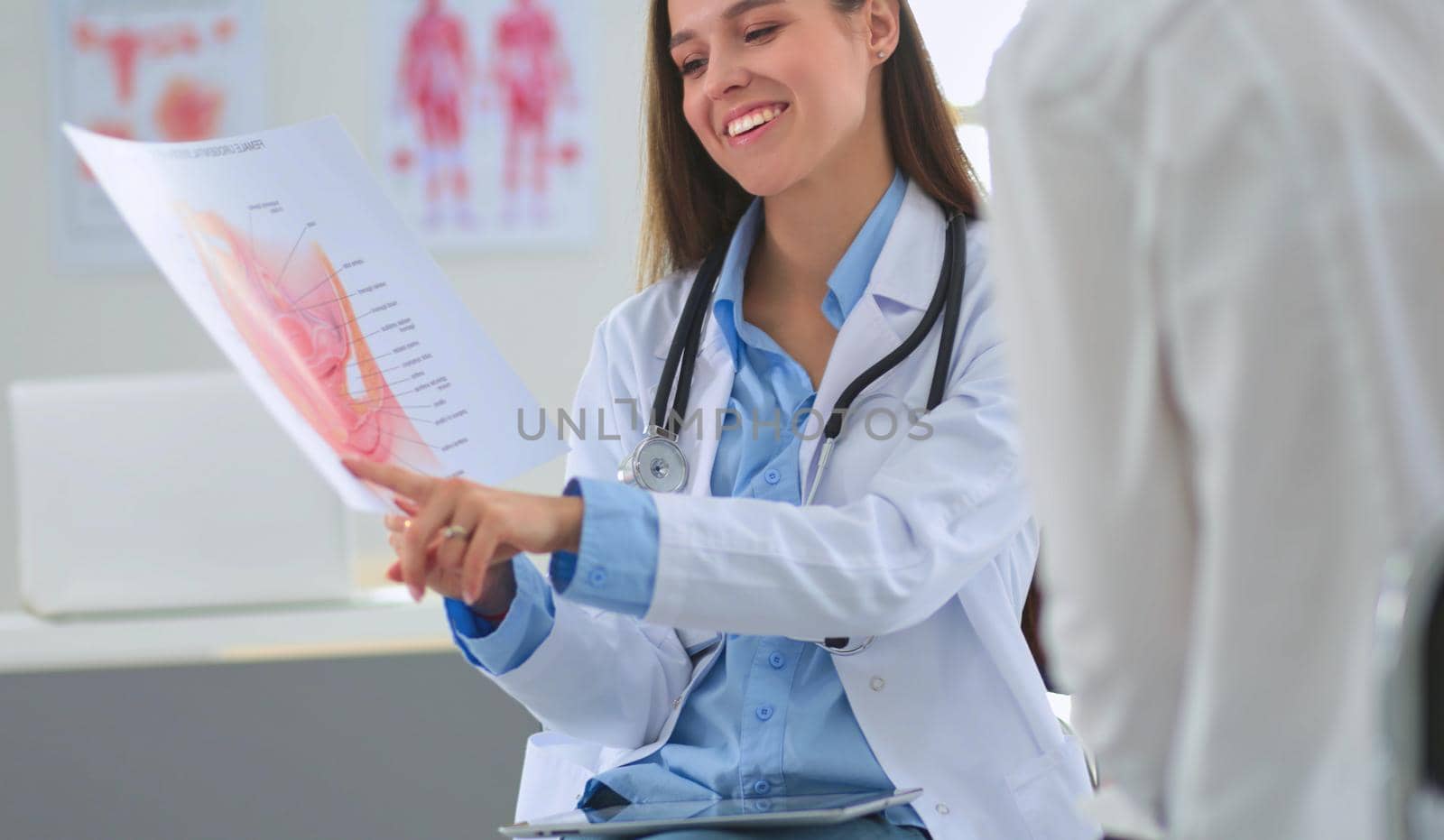 Doctor and patient discussing something while sitting at the table . Medicine and health care concept.