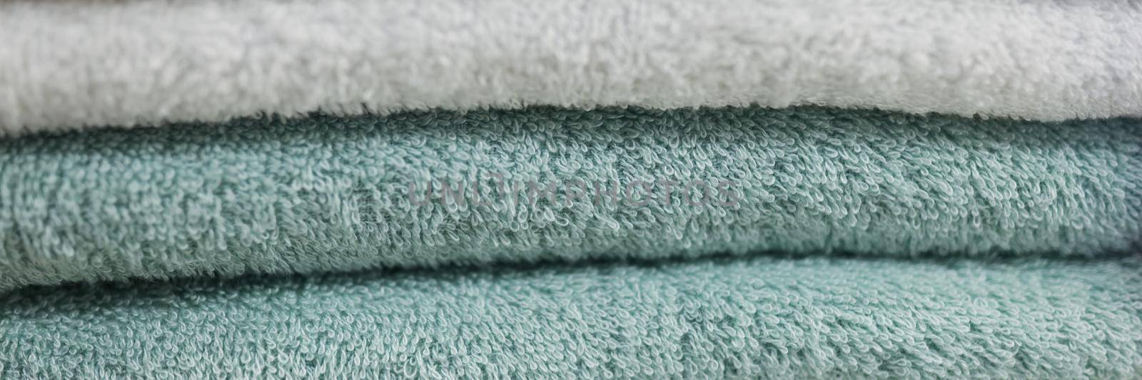 Close-up of set of fluffy clean towels available for guest use. Stack of fresh smelly tissue for hygiene use. Household, tidy, care, hotel, service concept