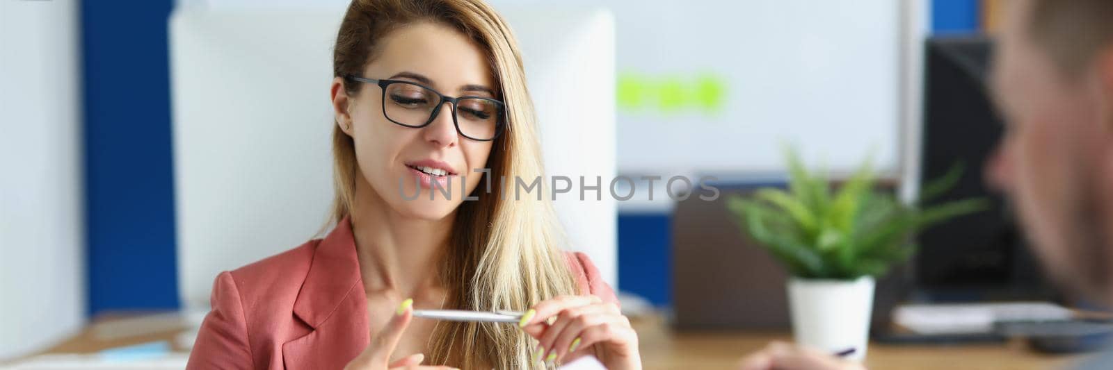 Portrait of workers meet in office to talk on important issue for company. Woman in suit hold pen and explain idea to colleague. Business, creative concept