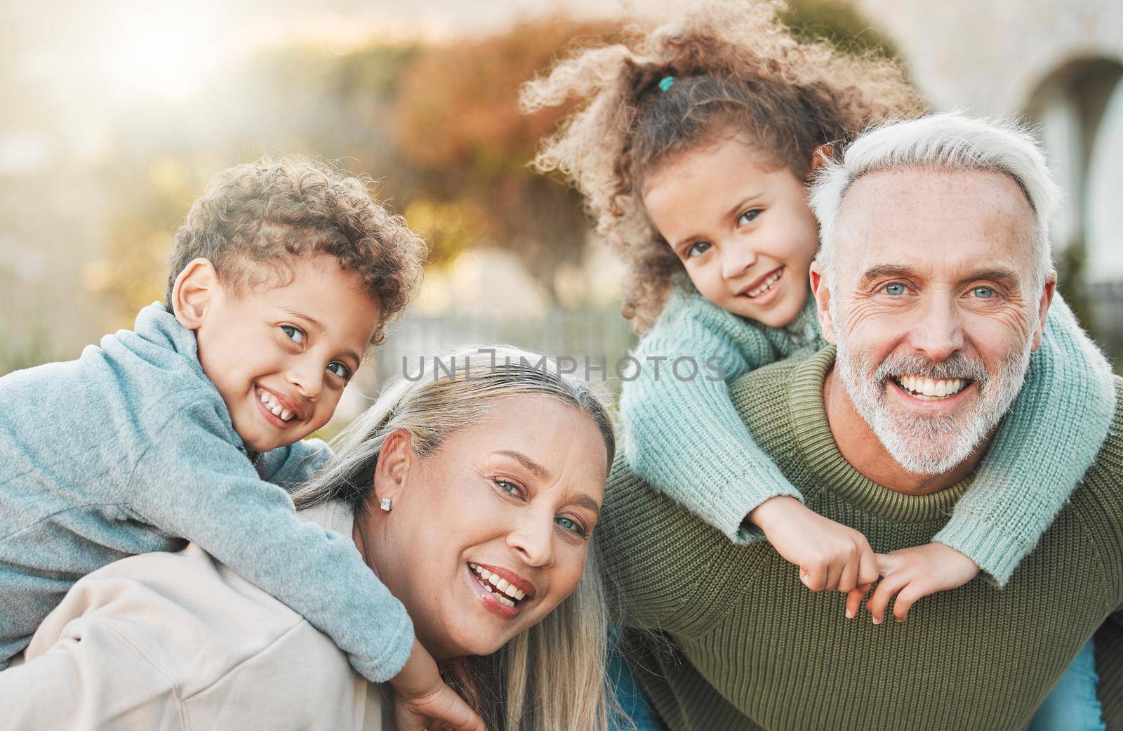 a senior couple spending time outdoors with their grandchildren.