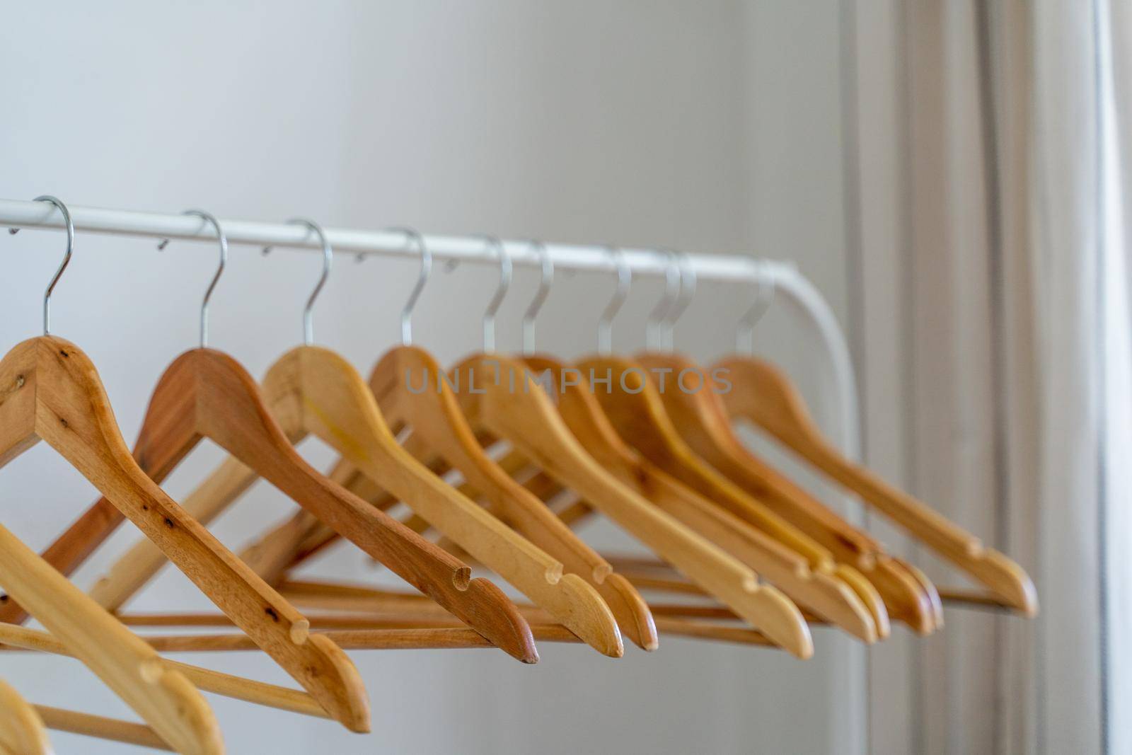 Close-up of wardrobe with wooden clothes hanger