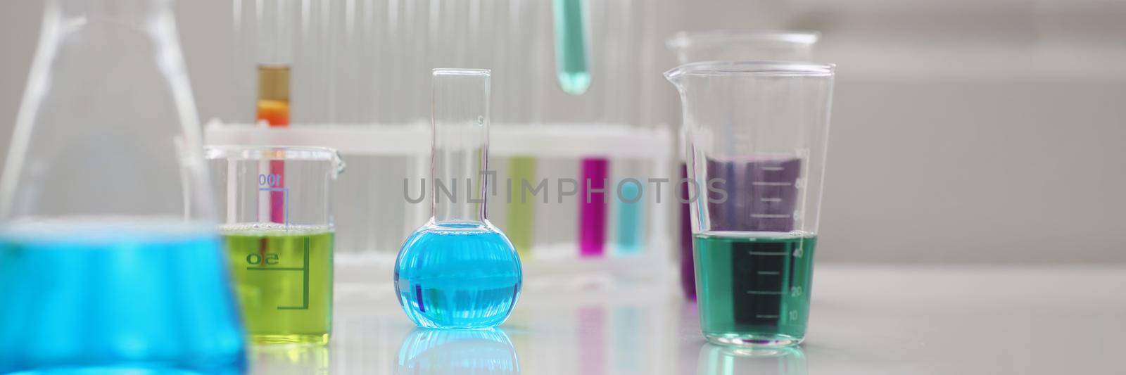 Close-up of working mess, lab tubes stand on table in laboratory of liquid testing, test development, substances poisons. Chemistry, medicine, lab concept