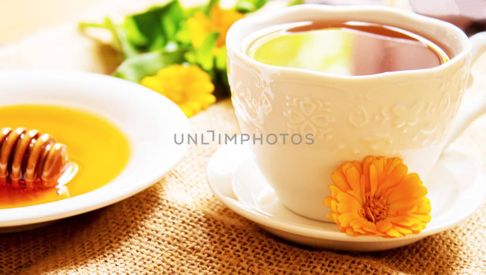honey with dandelions. cup of tea with dandelion. selective focus.nature