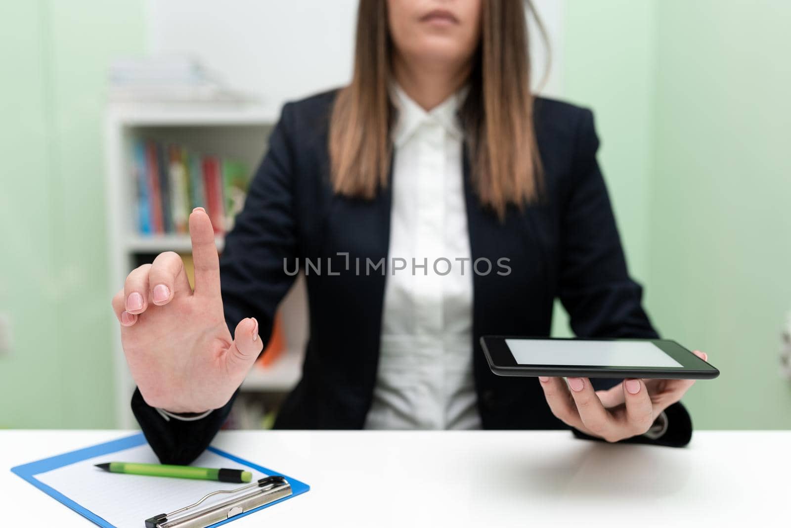 Woman Holding Tablet With One Hand And Pointing New Ideas With One Finger.