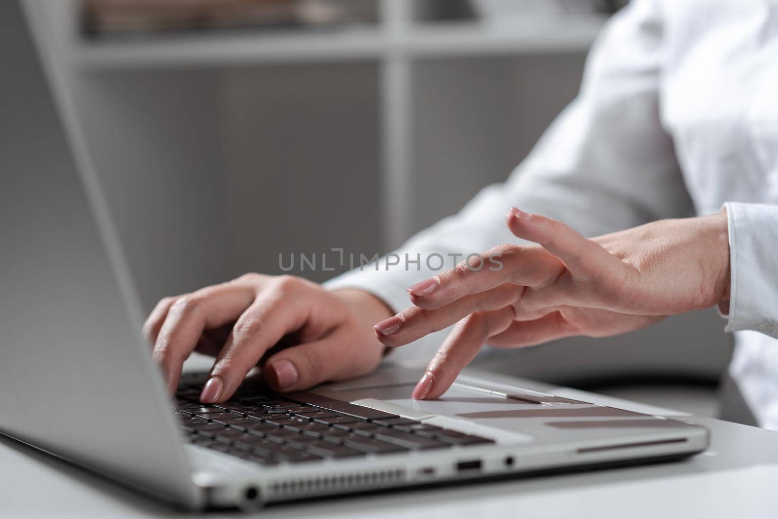 Businesswoman Typing Recent Updates On Lap Top Keyboard On Desk.