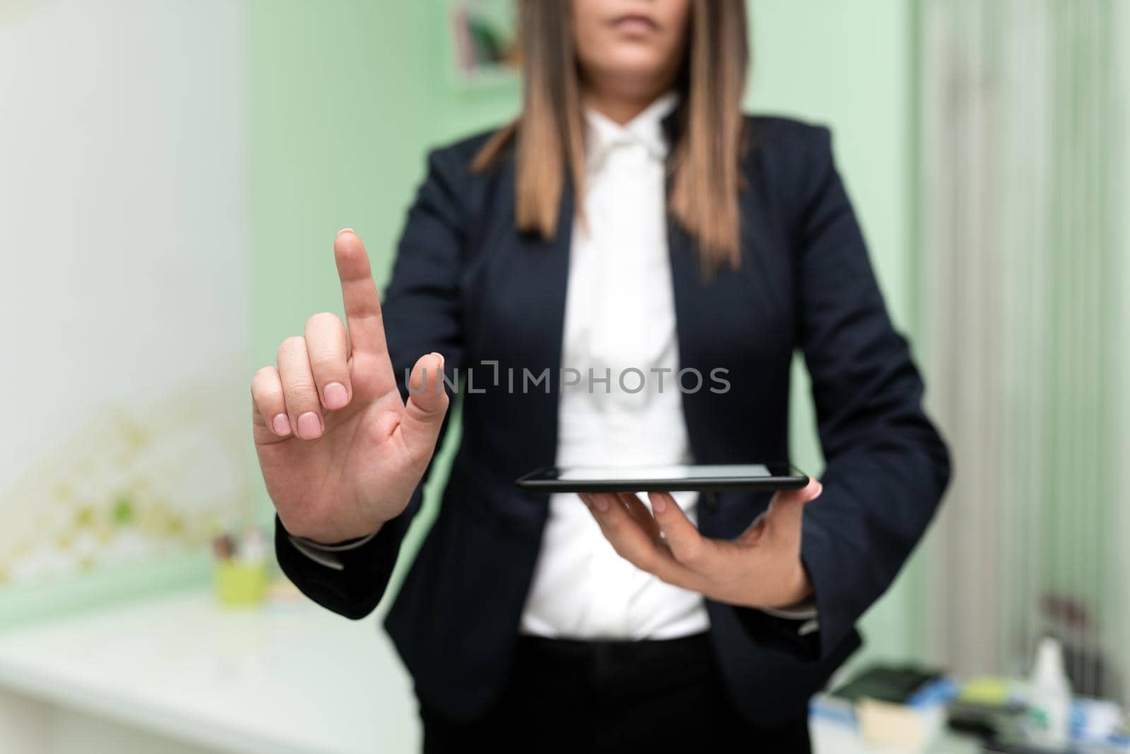 Businesswoman Holding Cellphone And Pointing Important Ideas With One Finger. Woman Having Phone And Showing Recent Updates On Screen. Executive Displaying Late News. by nialowwa