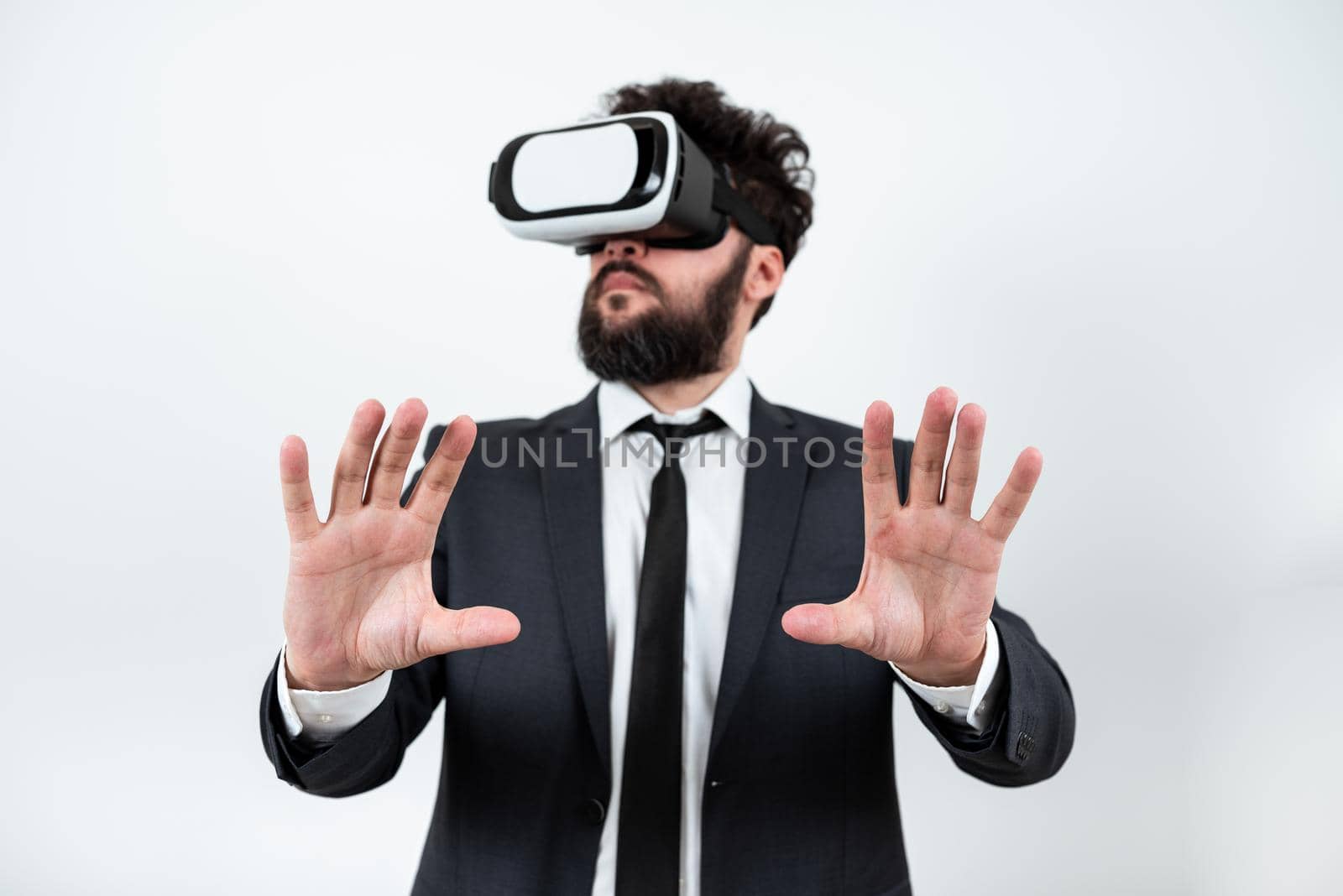 Man Wearing Vr Glasses And Presenting Important Messages Between Hands. Businessman Having Virtual Reality Eyeglasses And Showing Crutial Informations. by nialowwa