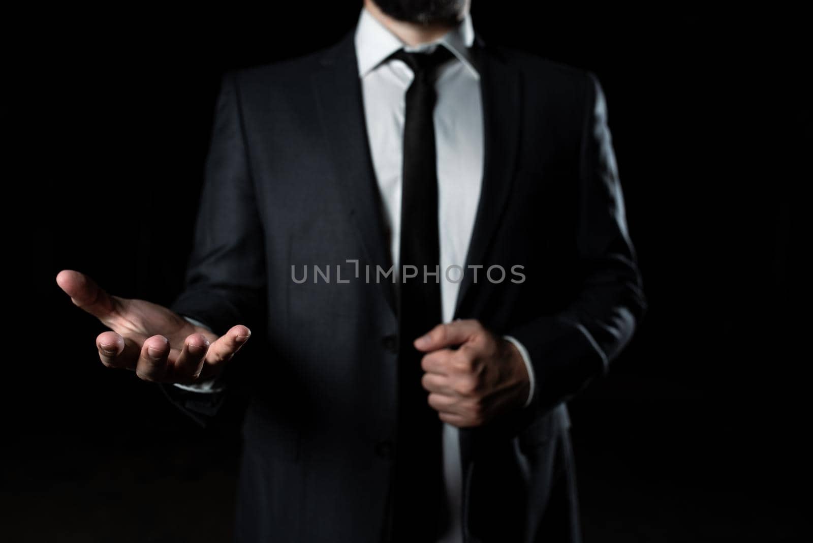 Businessman Holding Important Message In One Hand. Man In Suit Showing New Crutial Idea In A Palm. Executive Presenting Updated Critical Information. by nialowwa