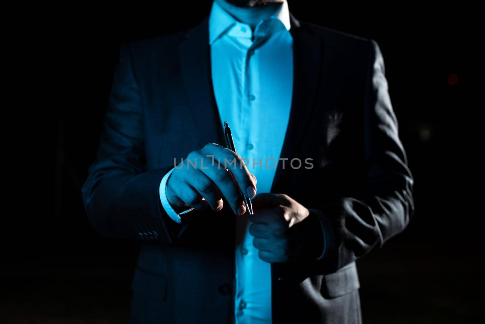 Businessman Pointing Important Informations With Pen In Hand.