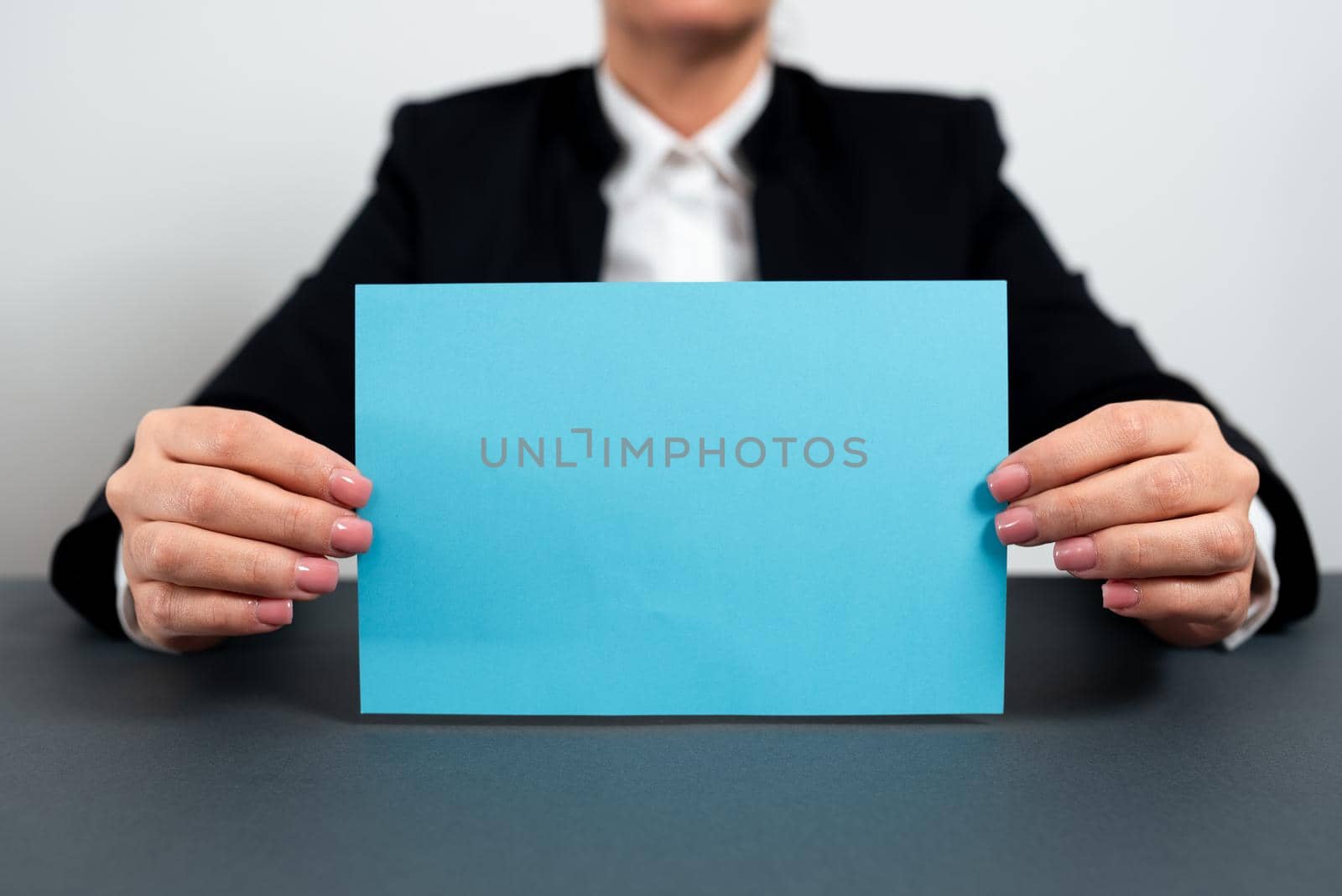 Businesswoman Holding Note With Important Message On Office Desk.