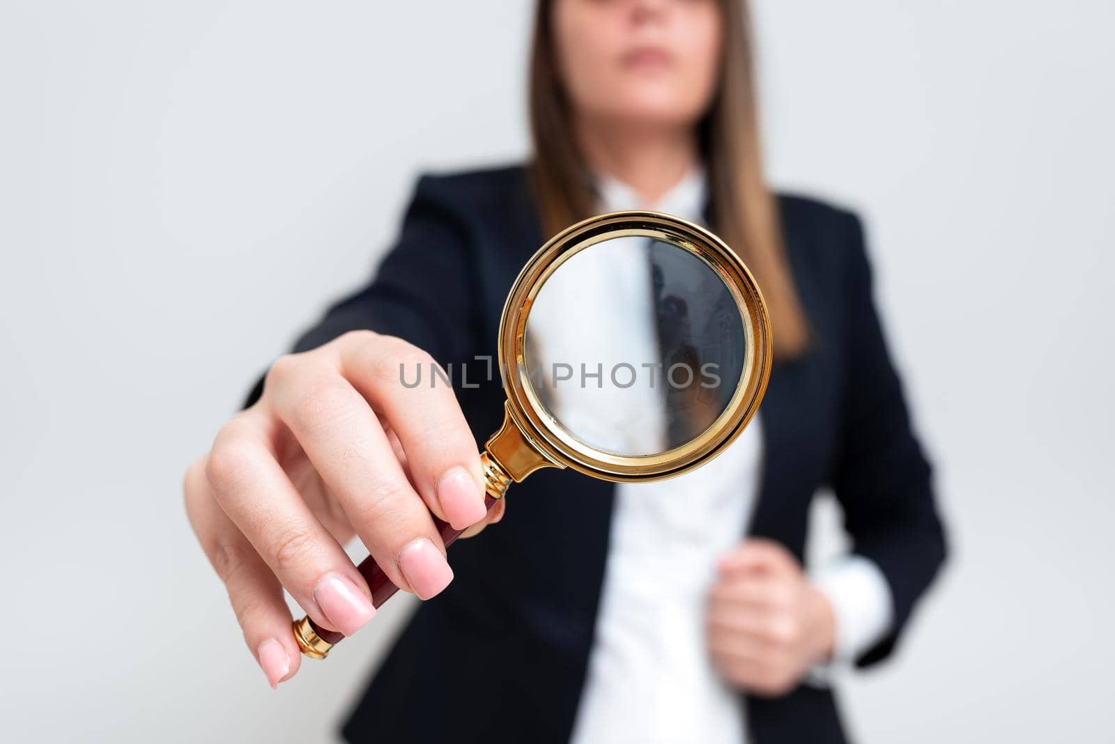 Businesswoman Holding Magnifier In One Hand. Woman Having Magnifying Glass To Point Important Information. Lady In Suit Zooming Crutial Message. Executive Presenting New Idea. by nialowwa