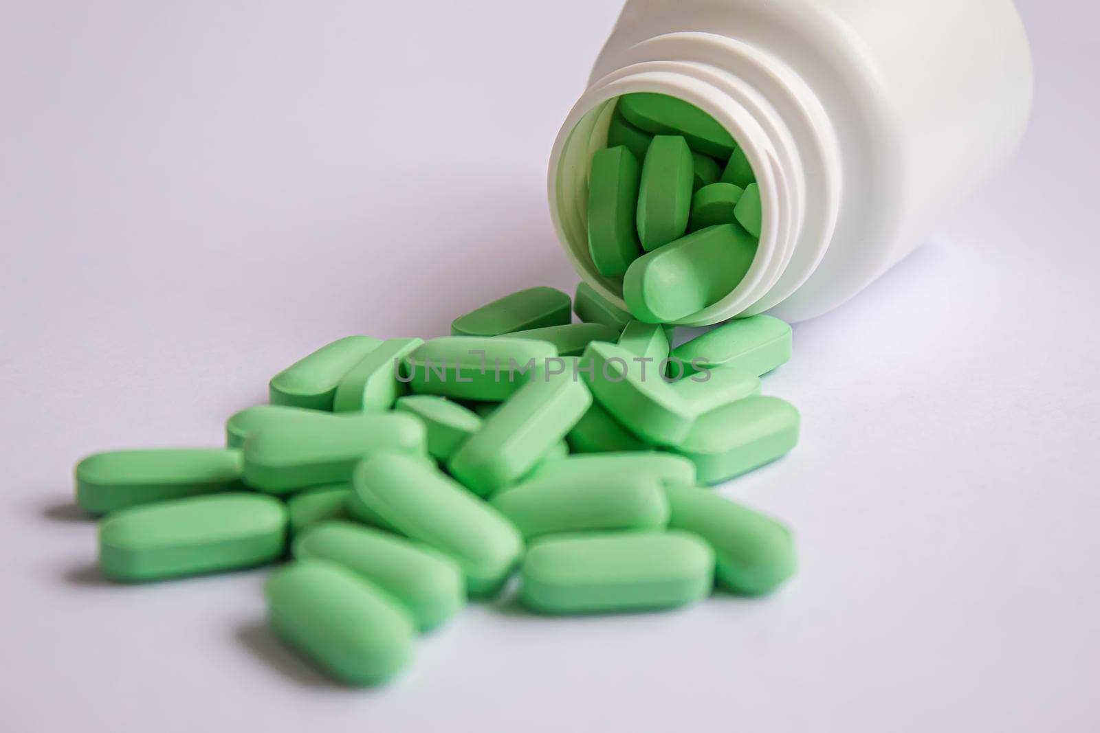 Vitamin tablets used as a dietary supplement.green tablets..selective focus.medical