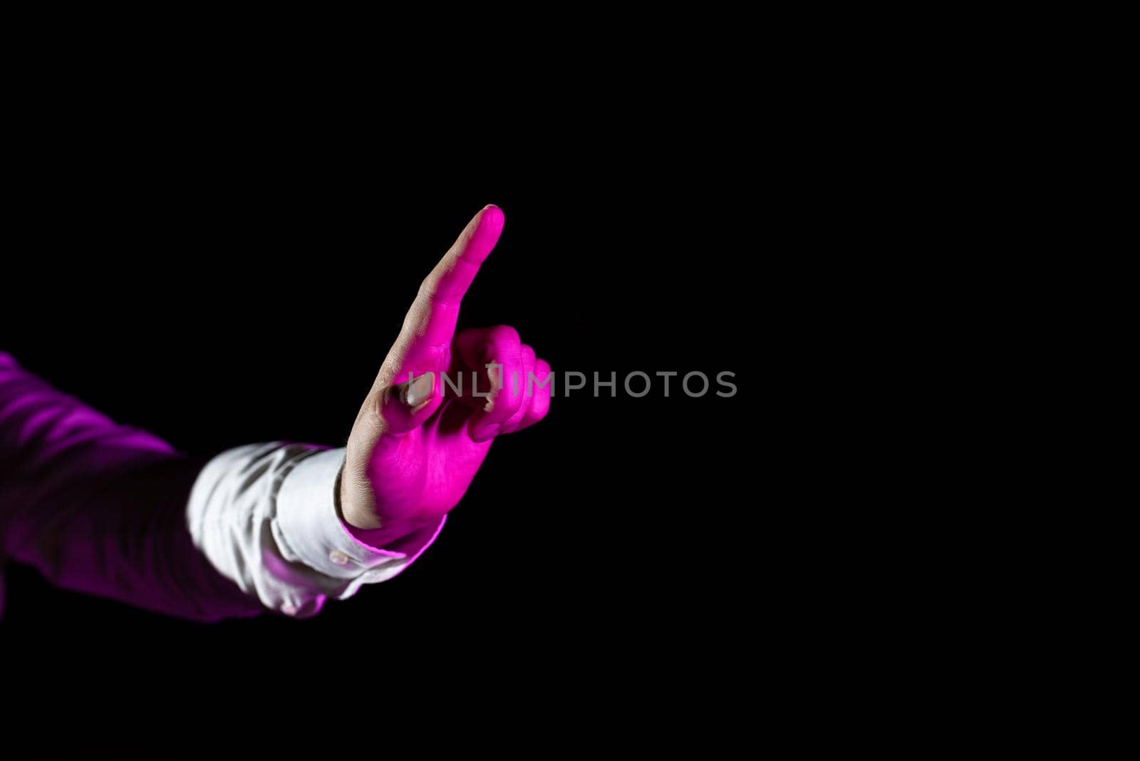 Hand Of Male Professional Pointing And Gesturing While Taking Training Through Virtual Reality Simulator. Light Falling On Man Finger Presenting Futuristic Technology. by nialowwa