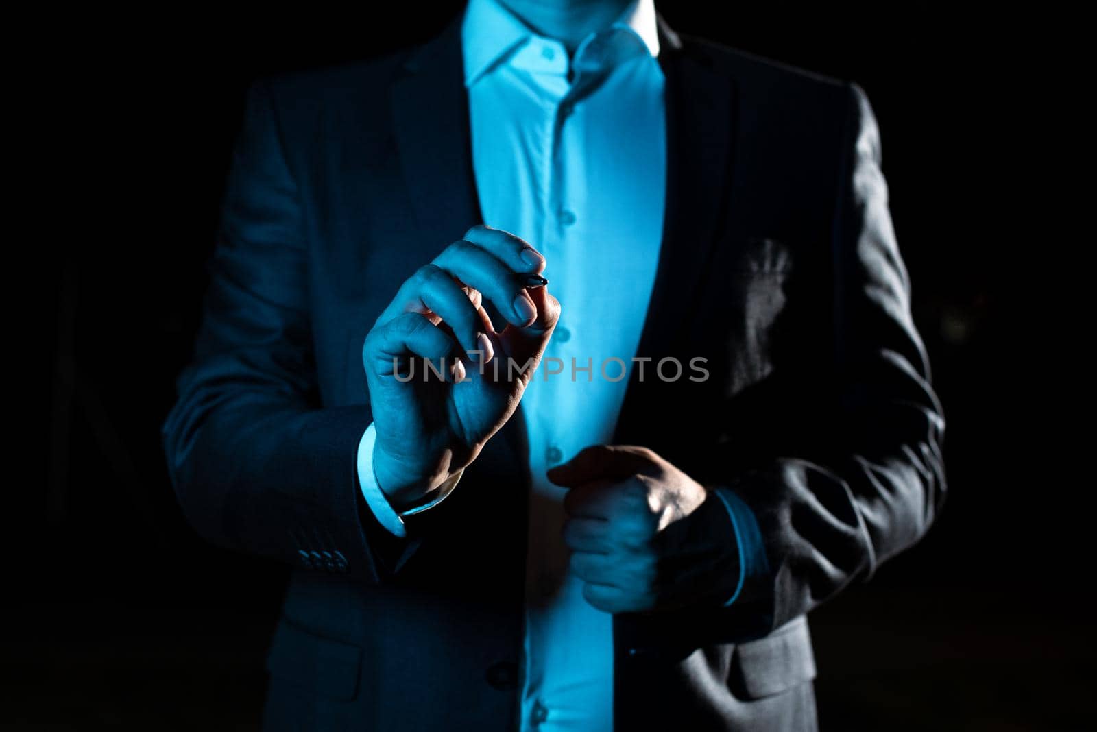 Businessman Pointing Important Informations With Pen In Hand.