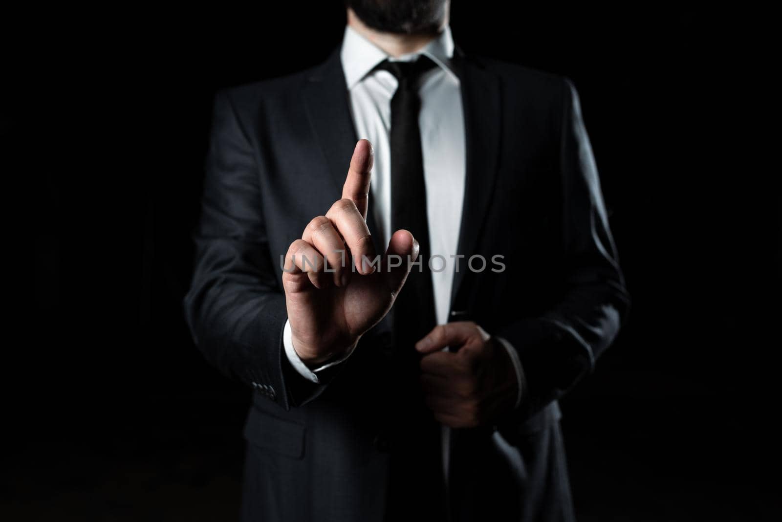 Businessman Pointing With One Finger On Important Message. Executive In Suit Presenting Crutial Information. Gentleman Showing Critical Announcement. by nialowwa