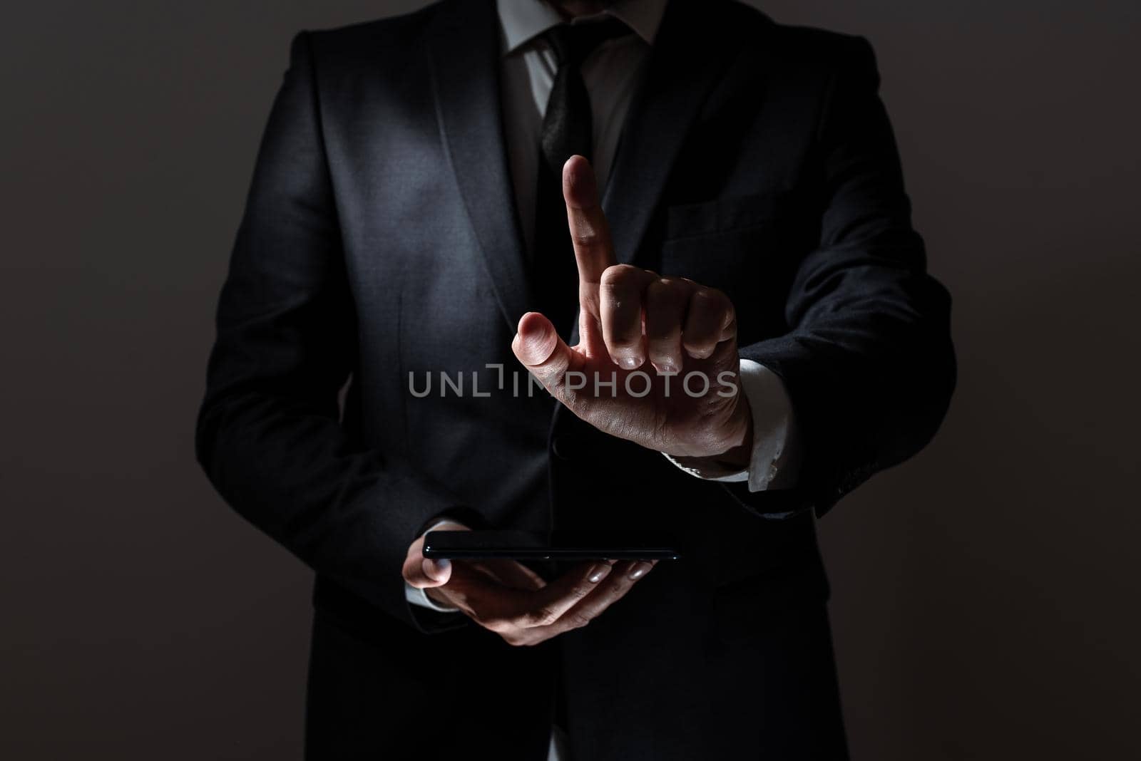 Businessman Holding Tablet And Pointing With One Finger On Important Message. Executive In Suit Presenting Crutial Information. Gentleman Showing Critical Announcement. by nialowwa