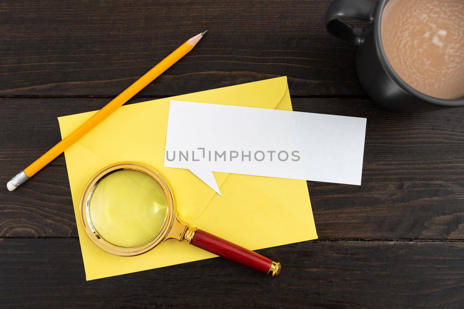 Thought Bubble Paper With Envelope, Coffee Cup And Stationery On Wooden Background. Important Ideas And Strategies With Drink On Table. It Is Showing Crucial News. by nialowwa