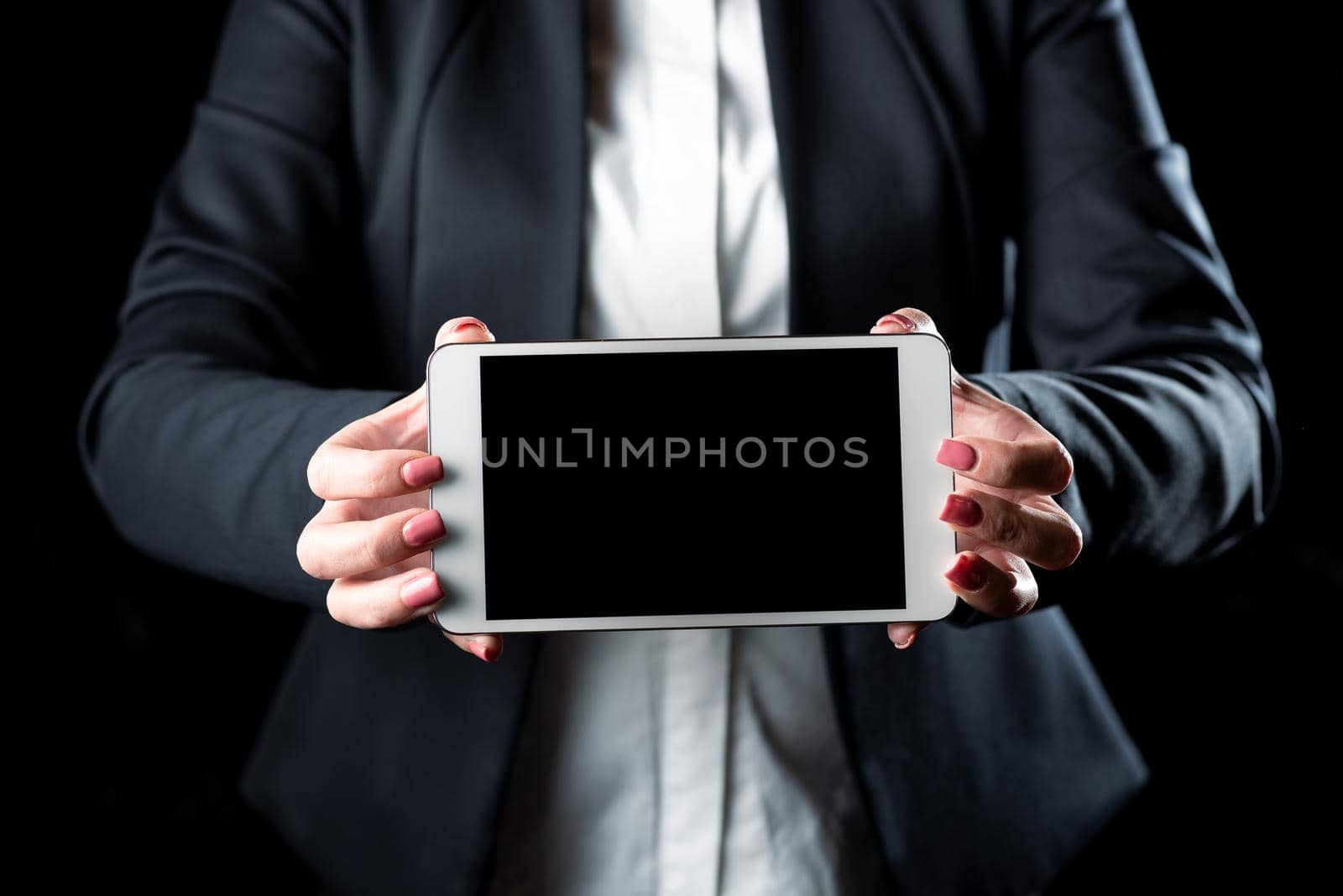 Businesswoman Holding Tablet And Presenting Important Informations On It. Woman Showing Recent Updates On Screen. Executive Displaying Late Achievements On Cellphone. by nialowwa