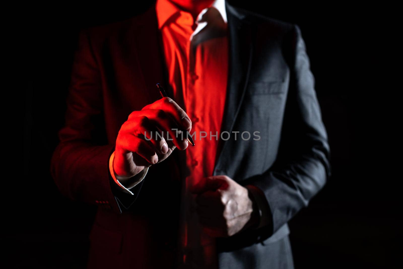 Businessman Pointing Important Informations With Pen In Hand.