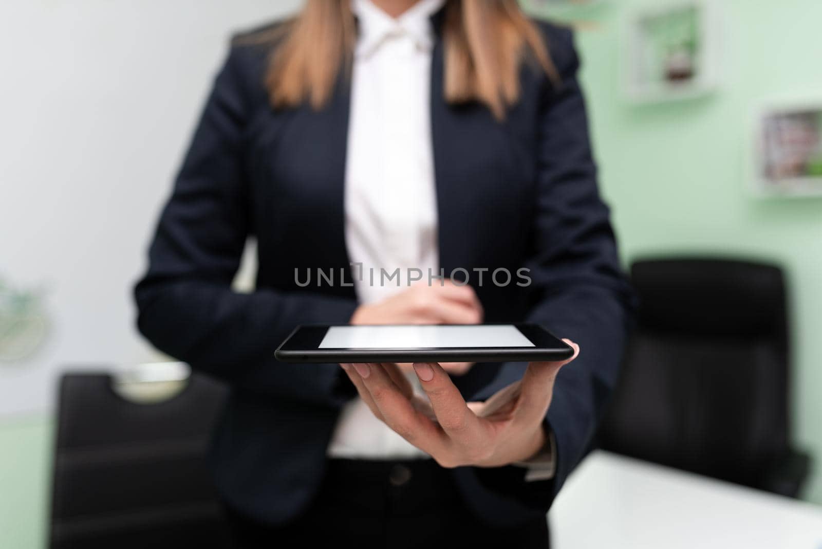 Businesswoman Holding Tablet And Presenting Important Message. Woman Having Phone In Hands And Showing Crutial Information. Executive Displaying Recent Updates. by nialowwa