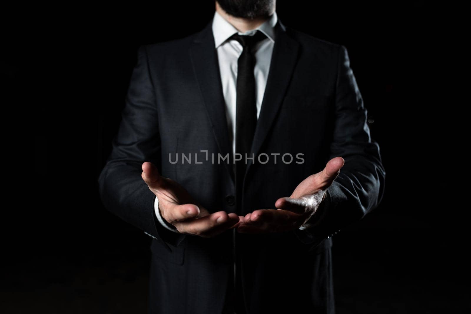 Businessman Holding Important Message In Both Hands. Man In Suit Showing New Crutial Idea In A Palms. Executive Presenting Updated Critical Information. by nialowwa