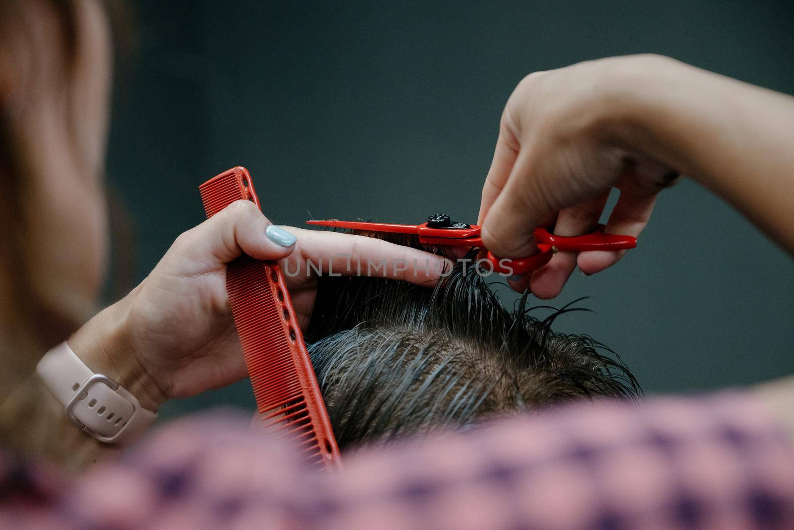 men haircut. hairdressing tools. hair cutting with scissors close-up.Close up of a haircut at a hair saloon