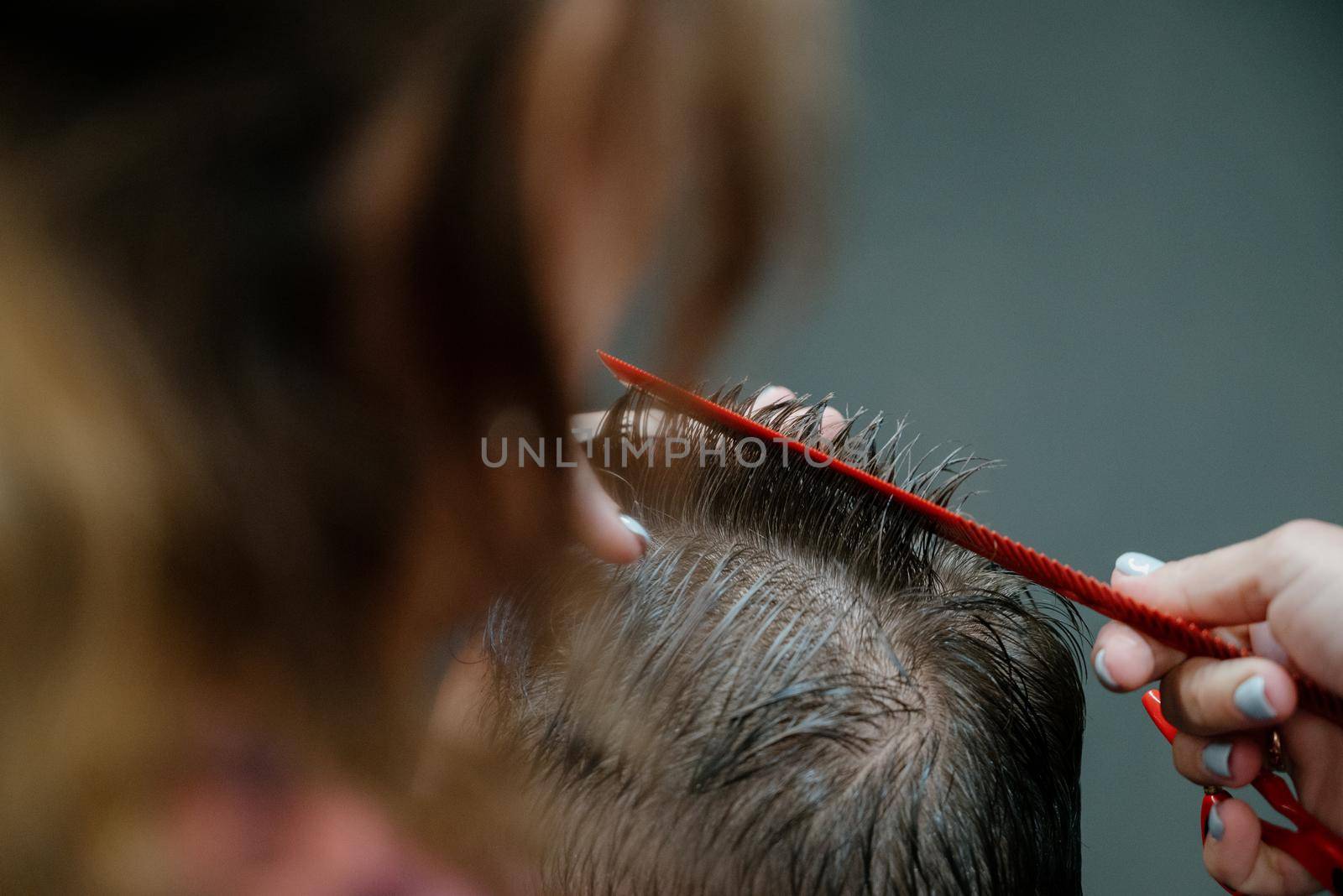 men haircut. hairdressing tools. hair cutting with scissors close-up.Close up of a haircut at a hair saloon