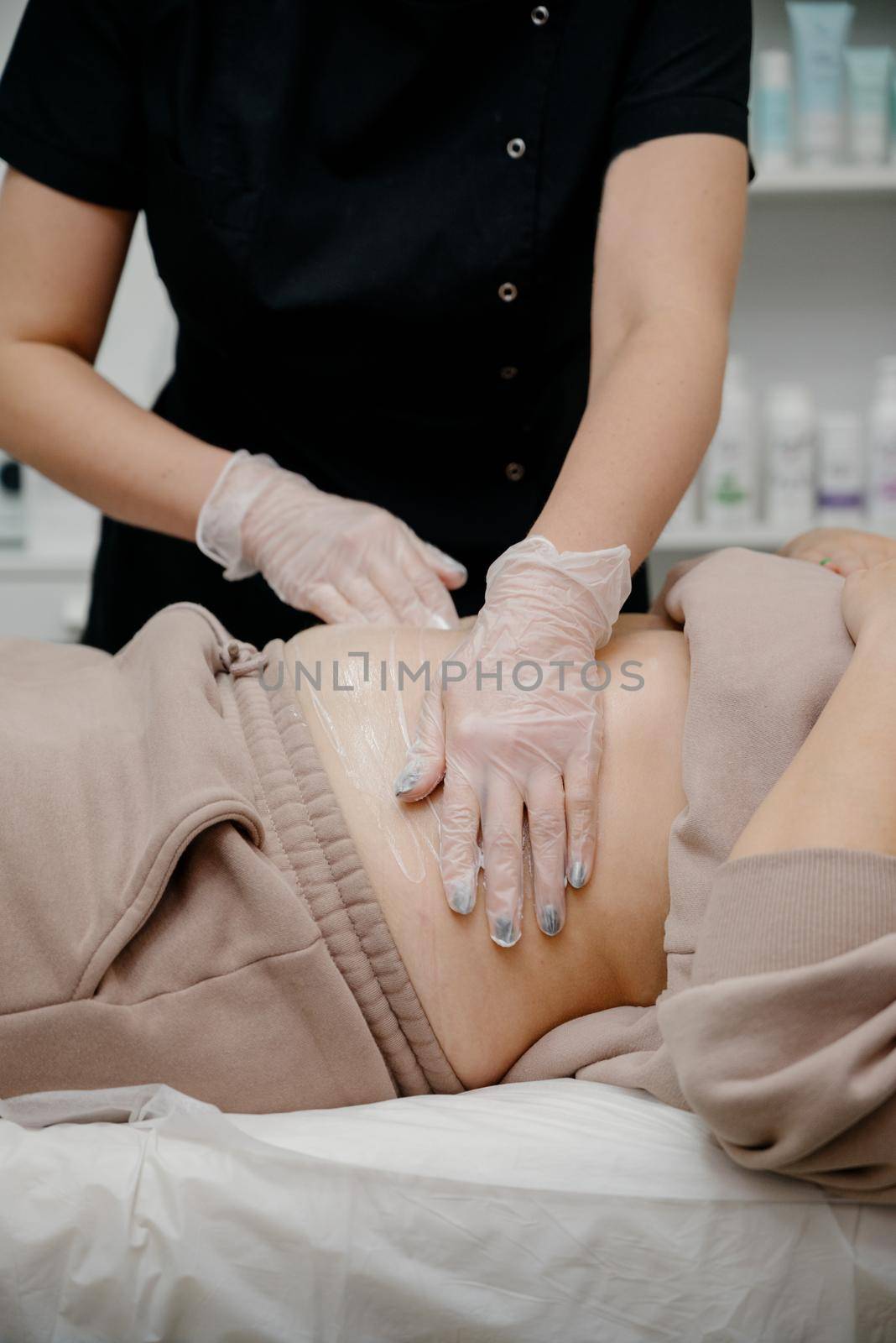 A woman in a beauty salon receives a vacuum abdominal massage, Hardware cosmetology.Hardware cosmetology for skin care and body contouring