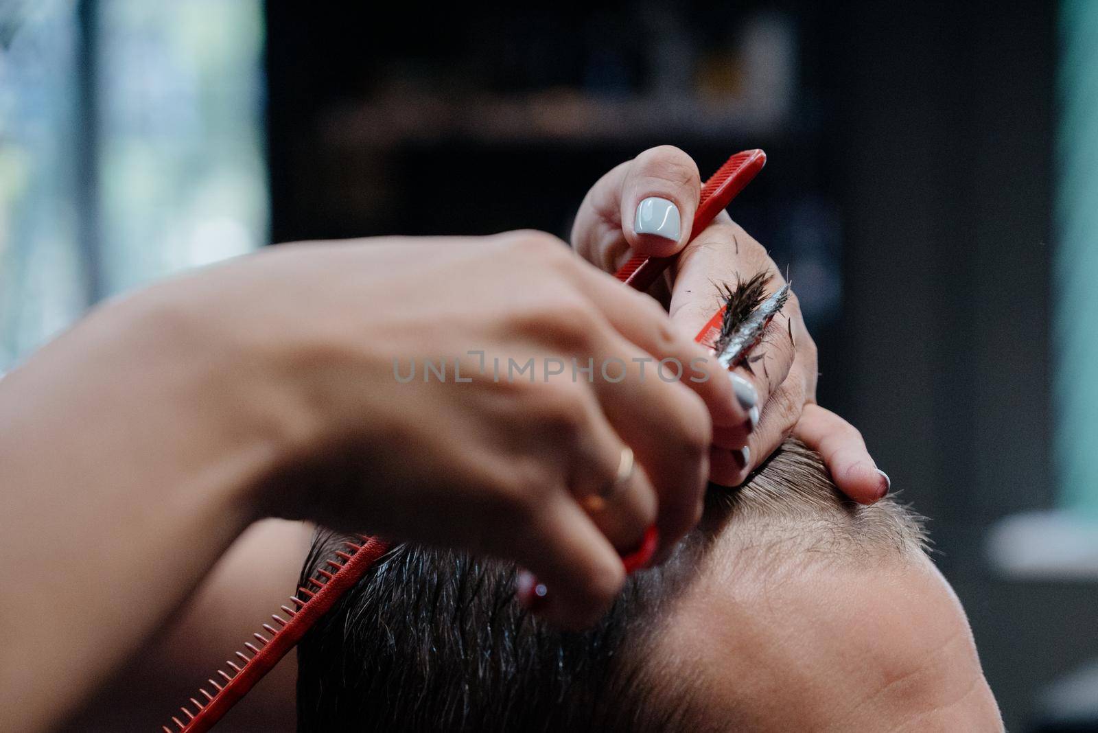 men haircut. hairdressing tools. hair cutting with scissors close-up.Close up of a haircut at a hair saloon