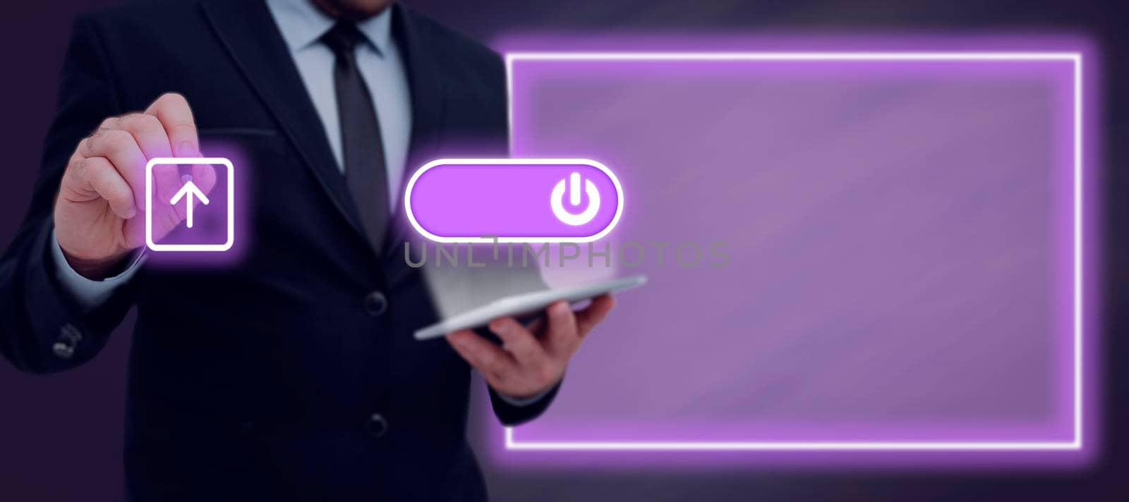 Businessman Showing A Power Button On A Tablet And Pen Pointing On Upload In A Futuristic Design. Man With Pen And Pad On Hand Uploading Important Files And Data. by nialowwa