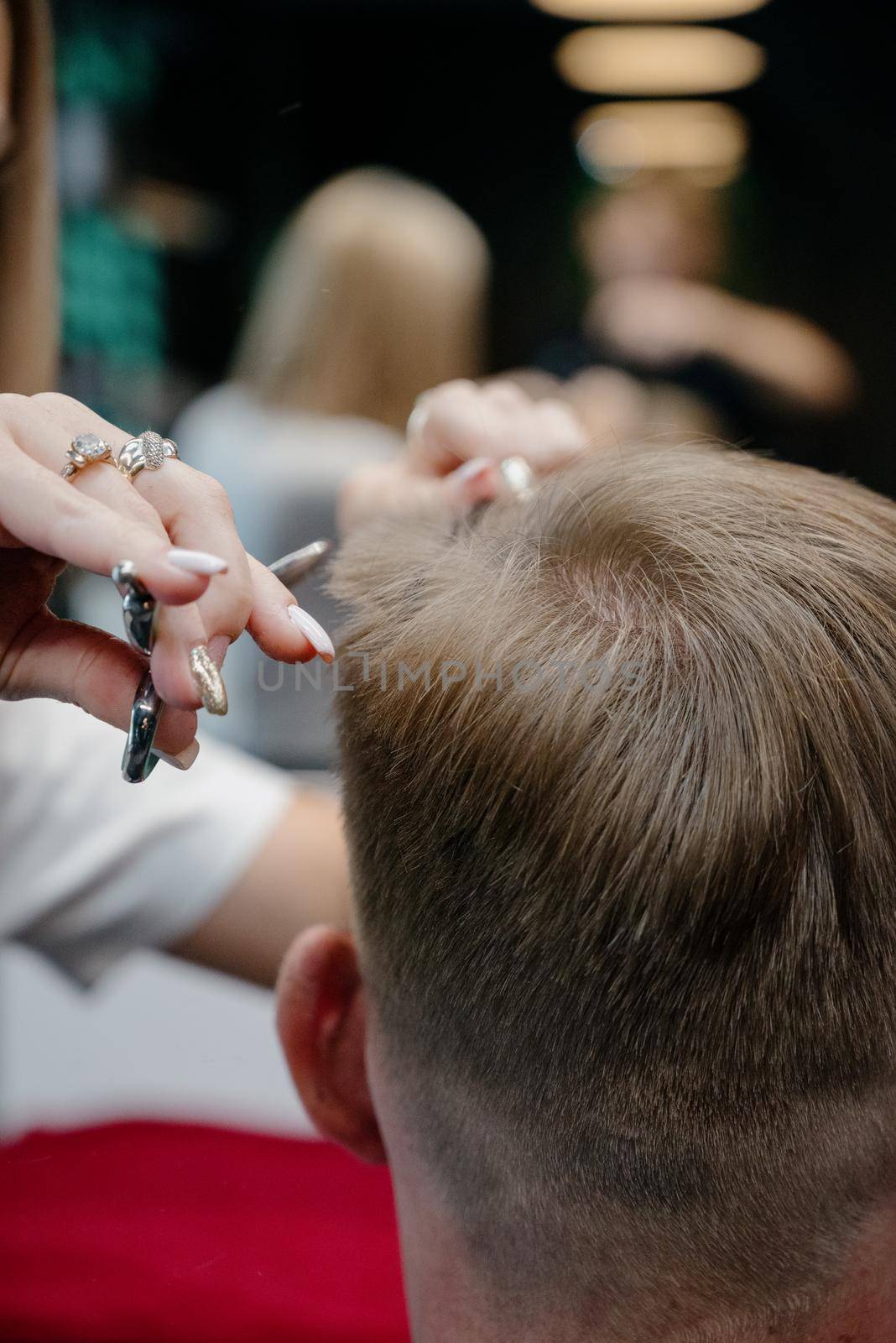 men haircut. hairdressing tools. hair cutting with scissors close-up.Close up of a haircut at a hair saloon