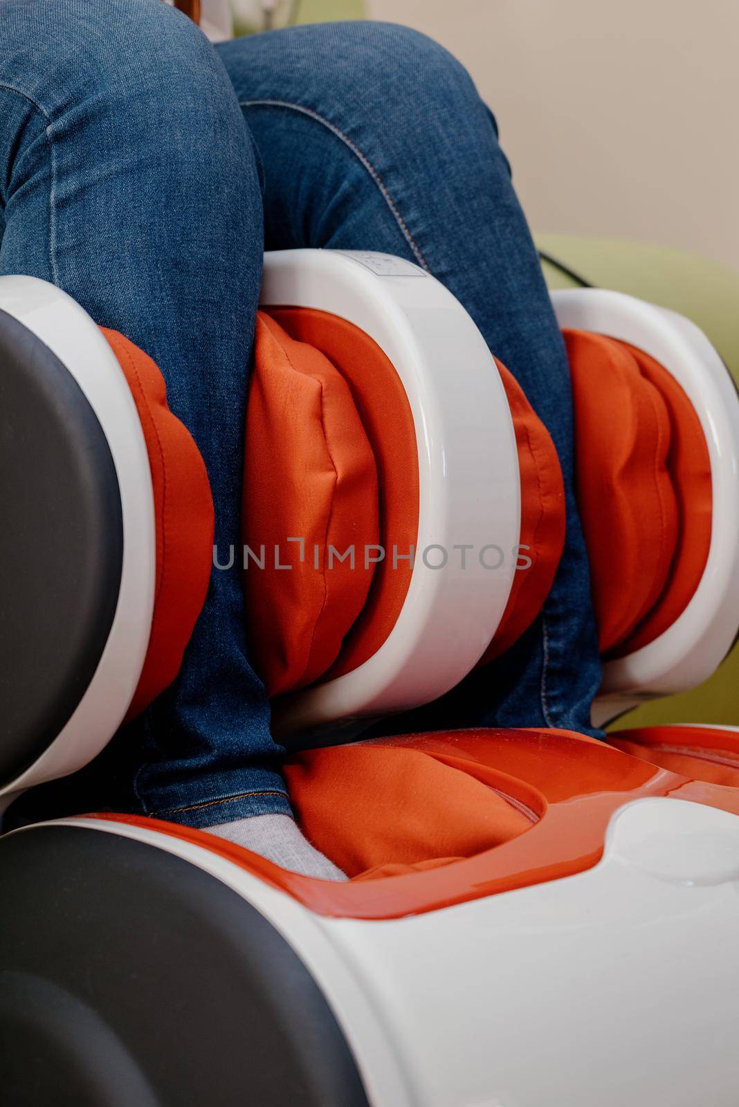 Woman relaxing in massage armchair.Closeup of legs of a woman relaxing on the electric massage chair