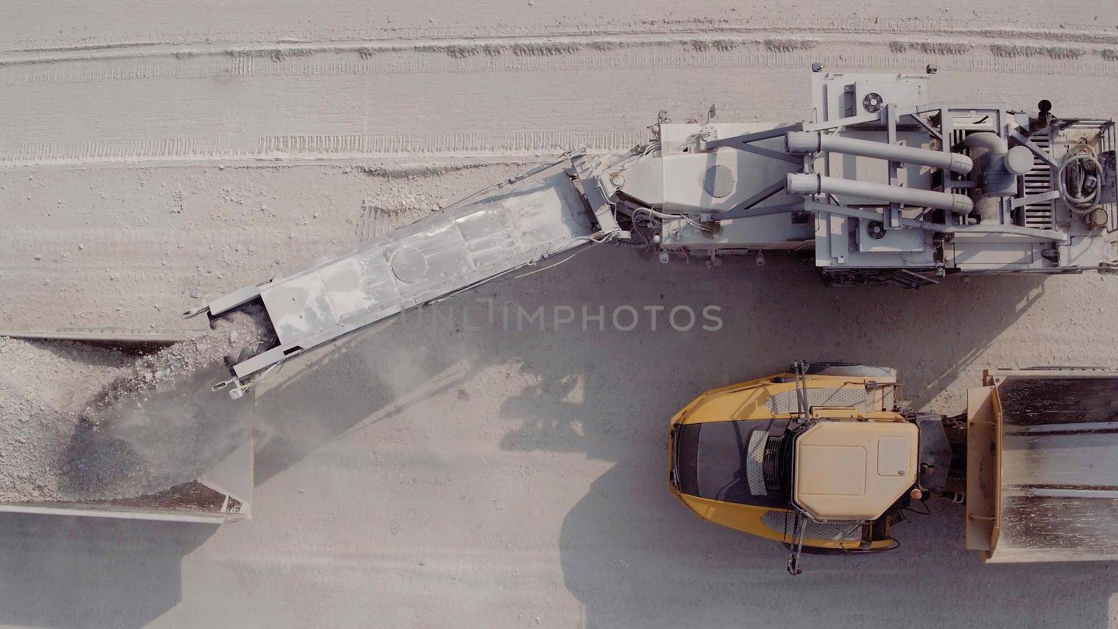 Large excavator in a lignite coal mine. Loading coal into truck. Mining car machinery to transport coal. Open pit mine quarrying extractive industry stripping work. Big Yellow Mining Trucks