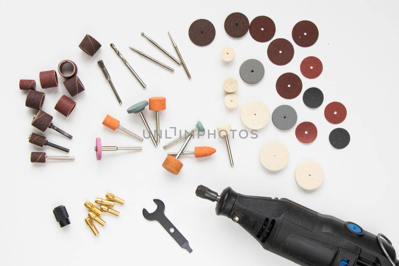 Dremel rotary kit, dremel heads, instrument for handwork on white background