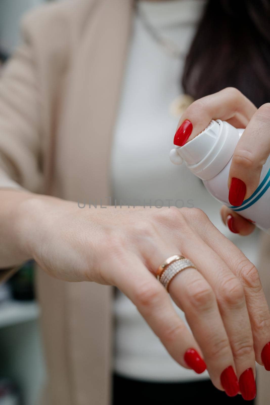 Close up of hands of woman preparing to apply gentle foam facial cleanser by Kovenkin